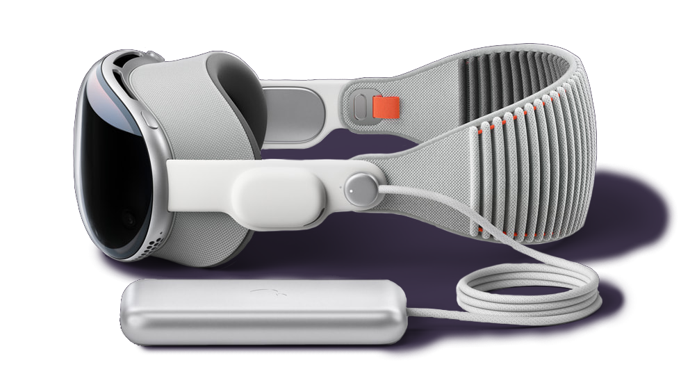 An Apple Vision Pro headset viewed from the side with the battery connected by wire sitting in front of it.